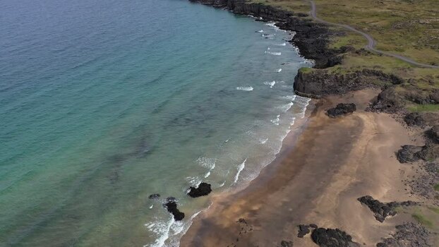 Aerial view of Skardsvik Beach with volcanic rocks Iceland.