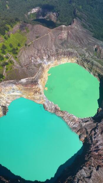 Aerial view of the turquoise crater lakes of Kelimutu National Park Indonesia. Aerial view of the turquoise crater lakes of Kelimutu National Park Indonesia.