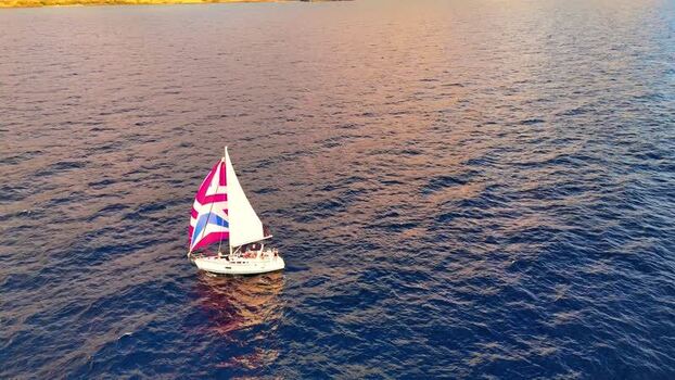 Aerial view of a sailboat with colorful sails United States. Aerial view of a sailboat with colorful sails United States.
