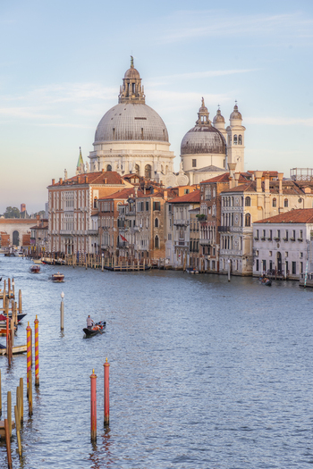 View of the Santa Maria della Salute basilica on the Grand Canal with historic buildings a gondola on the water and soft light in Venice Veneto Italy. View of the Santa Maria della Salute basilica on the Grand Canal with historic buildings a gondola on the water and soft light in Venice Veneto Italy.