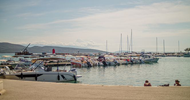 Krk Primorje Gorski Kotar Croatia 19 September 2026 View of a marina filled with motorboats and sailboats moored in the calm harbor under a bright sky with distant hills. Krk Primorje Gorski Kotar Croatia 19 September 2026 View of a marina filled with motorboats and sailboats moored in the calm harbor under a bright sky with distant hills.