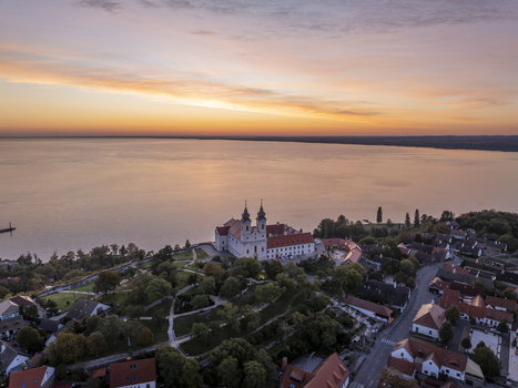 Aerial view of Tihany Abbey overlooking Lake Balaton at sunset with historic buildings and lush greenery in Tihany Hungary. Aerial view of Tihany Abbey overlooking Lake Balaton at sunset with historic buildings and lush greenery in Tihany Hungary.