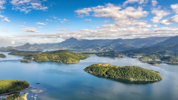 Aerial view of Angra dos Reis featuring lush green islands scattered across the calm blue bay surrounded by coastal mountains in Angra dos Reis Rio de Janeiro Brazil.