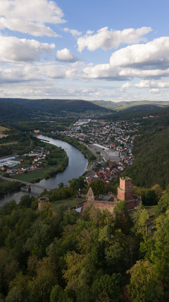 Aerial view of Burg Freudenburg overlooking the town and the river surrounded by lush forests and rolling hills in Freudenberg Baden Wurttemberg Germany.