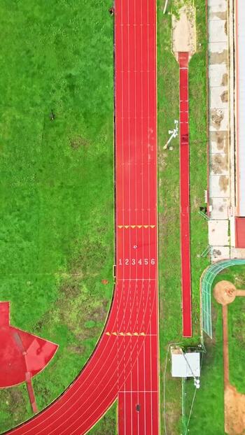 Aerial view of a red running track and green grass in Merida Mexico. Aerial view of a red running track and green grass in Merida Mexico.