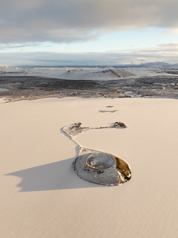 Aerial view of Myvatn volcanic landscape with snow covered craters and frozen lake under soft winter light in Thingeyjarsveit Iceland. Aerial view of Myvatn volcanic landscape with snow covered craters and frozen lake under soft winter light in Thingeyjarsveit Iceland.