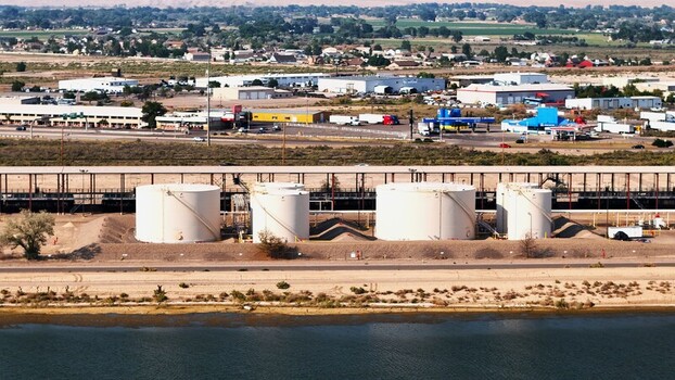 Grand Junction Colorado United States 03 July 2026 Aerial view of industrial storage tanks located near a river with a highway and commercial buildings in the background. Grand Junction Colorado United States 03 July 2026 Aerial view of industrial storage tanks located near a river with a highway and commercial buildings in the background.