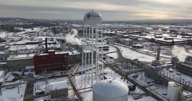 Aerial view of the GE Aerospace facility and water tower in winter United States. Aerial view of the GE Aerospace facility and water tower in winter United States.