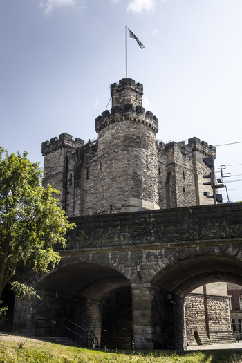 View of the historic Newcastle Castle Keep featuring stone battlements and arched masonry under a clear blue sky in Newcastle upon Tyne England United Kingdom. View of the historic Newcastle Castle Keep featuring stone battlements and arched masonry under a clear blue sky in Newcastle upon Tyne England United Kingdom.
