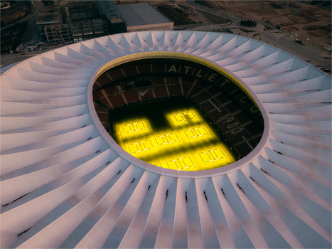 Aerial view of Riyadh Air Metropolitano Stadium with its distinctive white roof and illuminated pitch in Madrid Comunidad de Madrid Spain.