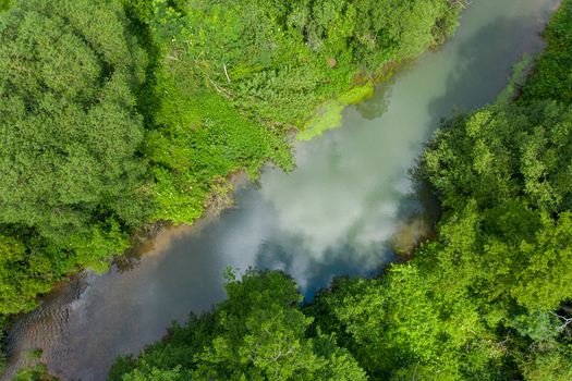 Aerial view of the Wasserwiesen river area with lush green trees and clouds reflecting in the water in Biberach an der Riss Baden Wurttemberg Germany.