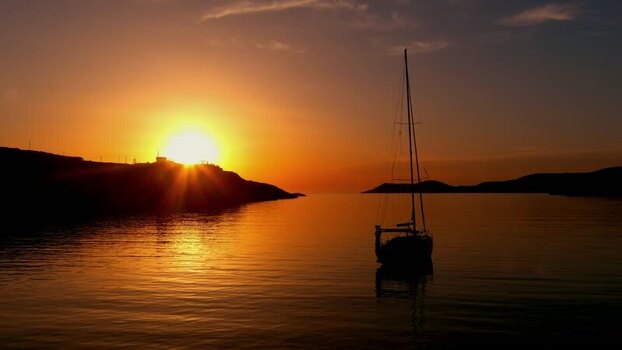 Aerial view of sailboat in a bay at sunset in Islands Greece. Aerial view of sailboat in a bay at sunset in Islands Greece.