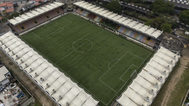 Aerial view of the Mobolaji Johnson Arena on Lagos Island with its distinctive white canopy roof and green pitch surrounded by urban infrastructure in Lagos Lagos Nigeria. Aerial view of the Mobolaji Johnson Arena on Lagos Island with its distinctive white canopy roof and green pitch surrounded by urban infrastructure in Lagos Lagos Nigeria.