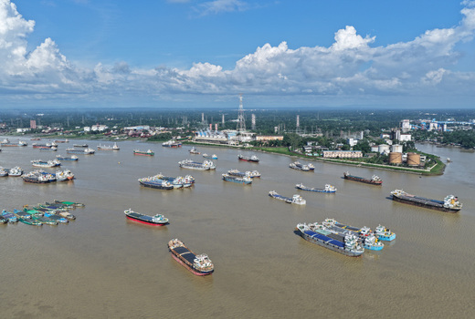 Aerial view of the Karnaphuli River filled with numerous cargo ships and industrial vessels near the riverbank in Chattogram Chattogram Division Bangladesh.
