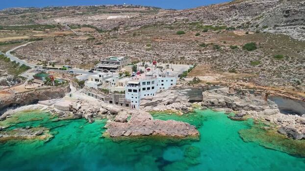 Aerial view of Ghar Lapsi Malta with cliffs turquoise water and shoreline. Aerial view of Ghar Lapsi Malta with cliffs turquoise water and shoreline.