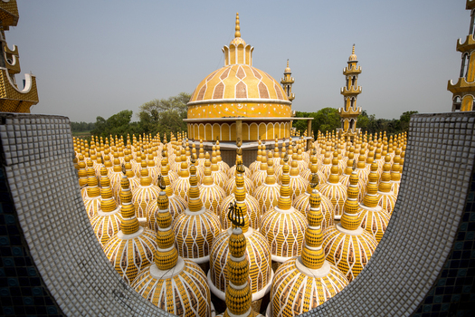 View of a mesmerizing golden domescape a sea of ornate structures under a hazy sky creating a stunning visual spectacle Tangail Bangladesh. View of a mesmerizing golden domescape a sea of ornate structures under a hazy sky creating a stunning visual spectacle Tangail Bangladesh.