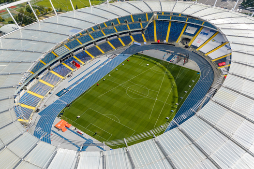 Chorzow Poland 17 September 2026 Aerial view of Silesian Stadium featuring a green football pitch blue running tracks and modern stadium seating under a clear sky.