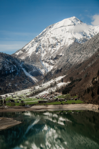 View of snow capped mountain reflecting serenely in the lake s calm waters a picturesque scene of nature s grandeur Train from Lucerne to Interlaken Switzerland. View of snow capped mountain reflecting serenely in the lake s calm waters a picturesque scene of nature s grandeur Train from Lucerne to Interlaken Switzerland.