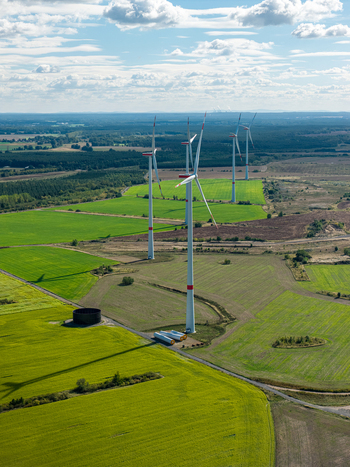 Aerial view of Windpark Forst Briesnig II situated on recultivated land of the former Janschwalde open pit mine with wind turbines rising above green fields in Forst Brandenburg Germany. Aerial view of Windpark Forst Briesnig II situated on recultivated land of the former Janschwalde open pit mine with wind turbines rising above green fields in Forst Brandenburg Germany.