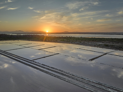 Aerial view of Saline dello Stagnone salt pans reflecting the golden sunset sky in Marsala Sicilia Italy. Aerial view of Saline dello Stagnone salt pans reflecting the golden sunset sky in Marsala Sicilia Italy.