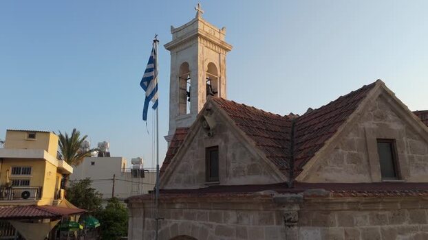 Aerial view of church tower with Greek flag in Nicosia Cyprus.