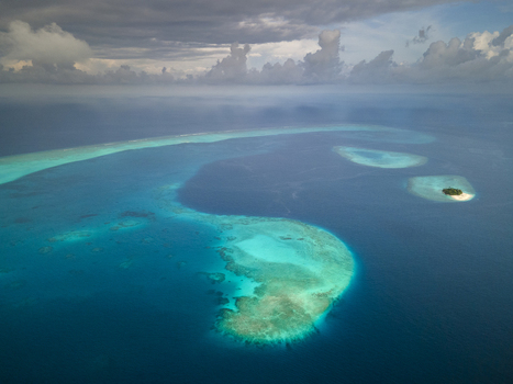 Aerial view of islands with white beach and blue ocean Baa Atoll Maldives.
