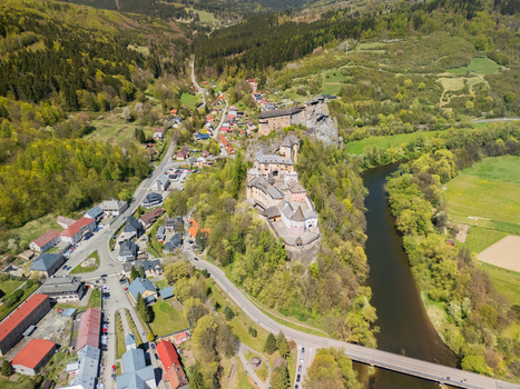 Aerial view of Orava Castle perched on a steep rock cliff above the Orava river and surrounding green forests in Dolny Kubin Zilinsky kraj Slovakia. Aerial view of Orava Castle perched on a steep rock cliff above the Orava river and surrounding green forests in Dolny Kubin Zilinsky kraj Slovakia.