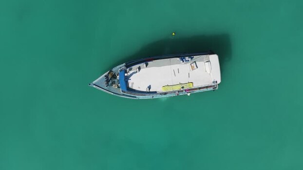 Aerial view of a white boat on turquoise water Maldives. Aerial view of a white boat on turquoise water Maldives.