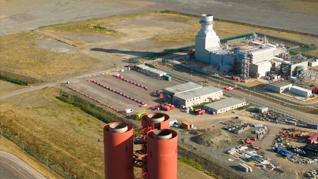 Aerial view of Millbrook Power Plant featuring large red chimneys and industrial infrastructure surrounded by open land in Stewartby England United Kingdom. Aerial view of Millbrook Power Plant featuring large red chimneys and industrial infrastructure surrounded by open land in Stewartby England United Kingdom.