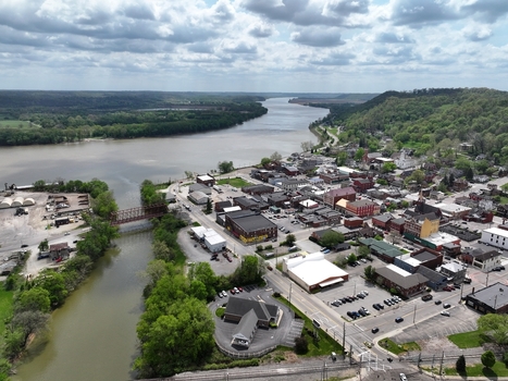 Aerial view of the historic riverfront town with lush green hills and a cloudy sky Aurora Indiana United States. Aerial view of the historic riverfront town with lush green hills and a cloudy sky Aurora Indiana United States.