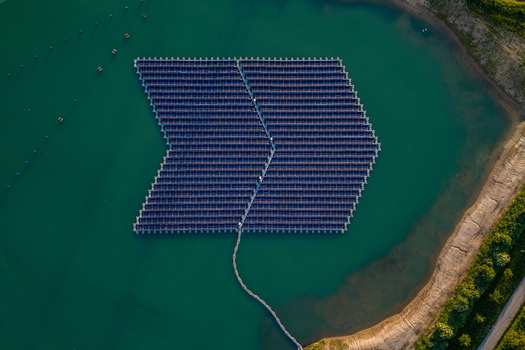 Aerial view of floating solar panels on a turquoise lake with a sandy shoreline in Bensheim Hessen Germany. Aerial view of floating solar panels on a turquoise lake with a sandy shoreline in Bensheim Hessen Germany.