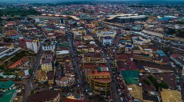 Aerial view of the dense urban landscape and the large modern Kejetia Market complex in Kumasi Ghana. Aerial view of the dense urban landscape and the large modern Kejetia Market complex in Kumasi Ghana.