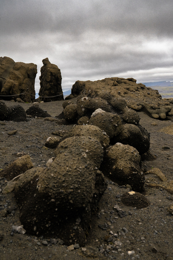 View of the rugged dark rocks and volcanic formations under a cloudy sky creating a stark dramatic landscape in Skaftárhreppur Skaftárhreppur Iceland. View of the rugged dark rocks and volcanic formations under a cloudy sky creating a stark dramatic landscape in Skaftárhreppur Skaftárhreppur Iceland.