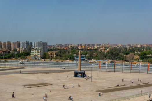 Giza Egypt 16 May 2026 View of the Grand Egyptian Museum plaza featuring the Hanging Obelisk with visitors walking under a clear blue sky.