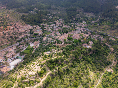 Aerial view of the historic village of Valldemossa with its stone architecture and lush green hillsides in Valldemossa Balearic Islands Spain.