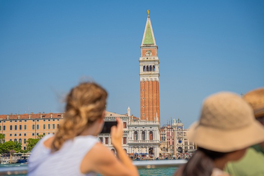 Venice Italy 29 March 2026 View of the iconic St. Mark s Campanile rising majestically against the clear blue sky framed by blurred figures and historic buildings. Venice Italy 29 March 2026 View of the iconic St. Mark s Campanile rising majestically against the clear blue sky framed by blurred figures and historic buildings.