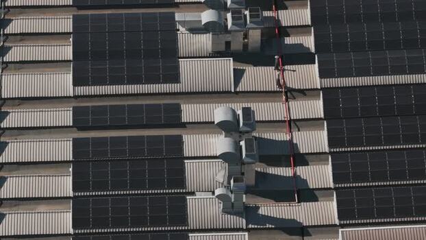 Aerial view of industrial rooftop with solar panels Italy.