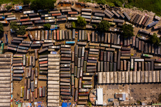 Aerial view of the crowded Gabtoli Bus Terminal with numerous buses parked in organized rows and urban infrastructure in Dhaka Dhaka Division Bangladesh.