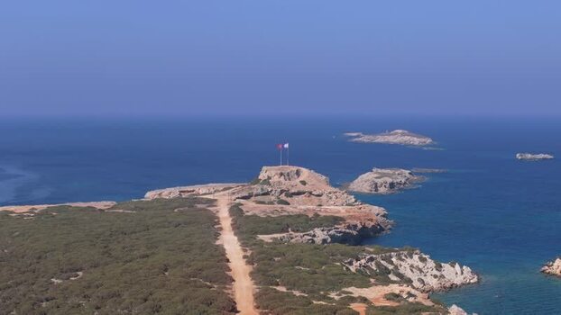 Aerial view of coastal cape with flags in Famagusta Northern Cyprus.