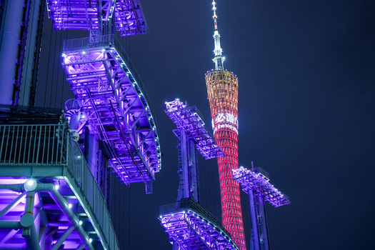 Guangzhou Guangdong Province China 23 February 2024 View of the illuminated Canton Tower rising above stadium lighting structures at night. Guangzhou Guangdong Province China 23 February 2024 View of the illuminated Canton Tower rising above stadium lighting structures at night.