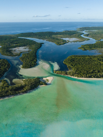 Aerial view of a shark nursery with turquoise waters meeting lush green islands under a vast sky Ouvéa Loyalty Islands Province New Caledonia. Aerial view of a shark nursery with turquoise waters meeting lush green islands under a vast sky Ouvéa Loyalty Islands Province New Caledonia.