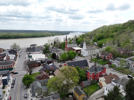 Aerial view of the historic town center featuring church steeples and residential houses along the Ohio River under a cloudy sky in Aurora Indiana United States. Aerial view of the historic town center featuring church steeples and residential houses along the Ohio River under a cloudy sky in Aurora Indiana United States.