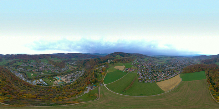 Aerial view of Ruine Pfeffingen castle ruins surrounded by lush green hills residential houses and autumn colored forests in Pfeffingen Basel Landschaft Switzerland. Aerial view of Ruine Pfeffingen castle ruins surrounded by lush green hills residential houses and autumn colored forests in Pfeffingen Basel Landschaft Switzerland.