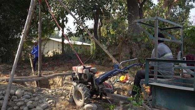 View of workers operating a drilling machine in Dhangadhi Nepal. View of workers operating a drilling machine in Dhangadhi Nepal.