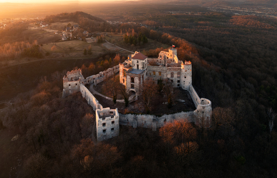 Aerial view of Tenczyn Castle ruins on a forested hill in the Krakow Czestochowa Upland during a golden sunset Krakow County Lesser Poland Voivodeship Poland. Aerial view of Tenczyn Castle ruins on a forested hill in the Krakow Czestochowa Upland during a golden sunset Krakow County Lesser Poland Voivodeship Poland.
