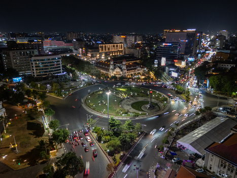 Aerial view of Tugu Muda monument and the historic Lawang Sewu building illuminated at night with traffic light trails circling the roundabout in Semarang Central Java Indonesia. Aerial view of Tugu Muda monument and the historic Lawang Sewu building illuminated at night with traffic light trails circling the roundabout in Semarang Central Java Indonesia.