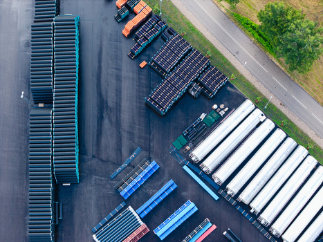 Aerial view of industrial storage yard filled with stacks of high efficiency polymer pipes and components in Jelgava Latvia. Aerial view of industrial storage yard filled with stacks of high efficiency polymer pipes and components in Jelgava Latvia.