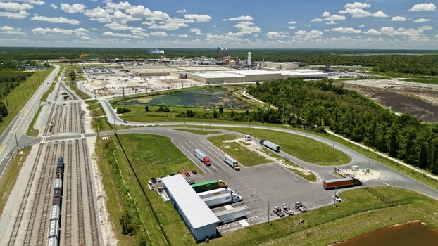 Aerial view of the Georgia Pacific Palatka Operations facility featuring industrial buildings rail tracks and trucks in Palatka Florida United States.