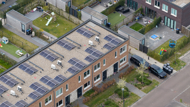 Aerial view of modern brick houses in the Nobelhorst neighborhood featuring solar panels on flat roofs and private backyards in Almere Flevoland Netherlands. Aerial view of modern brick houses in the Nobelhorst neighborhood featuring solar panels on flat roofs and private backyards in Almere Flevoland Netherlands.