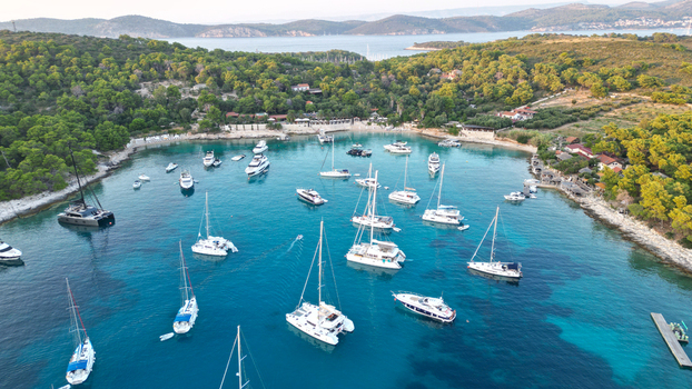 Hvar Croatia 21 August 2023 Aerial view of Vinogradisce bay with numerous yachts and sailboats anchored in turquoise waters surrounded by lush green hills. Hvar Croatia 21 August 2023 Aerial view of Vinogradisce bay with numerous yachts and sailboats anchored in turquoise waters surrounded by lush green hills.